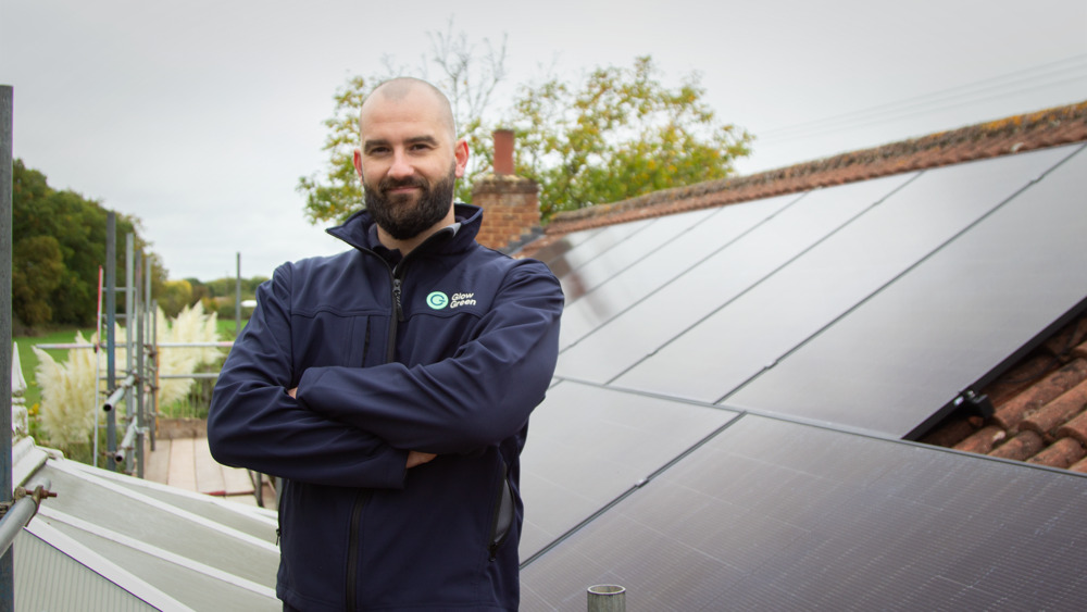 Glow Green solar installer with solar panels on roof