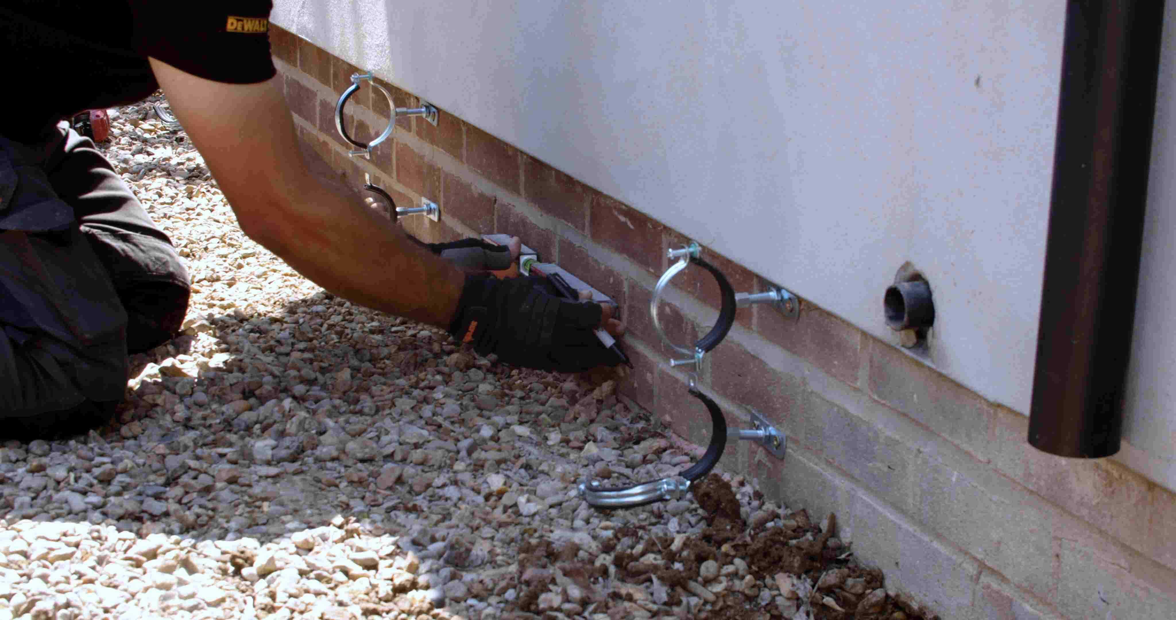 Pipes being fitted for heat pump install