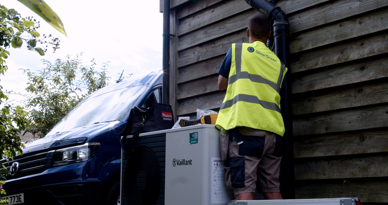 Vaillant heat pump being installed on side of house