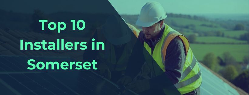 A team of solar panel installers in Somerset is seen working on a rooftop, securing panels and connecting wiring. The sun shines brightly in the background, highlighting the sustainable energy project