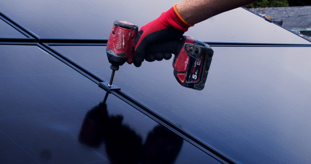 Solar panels being drilled into roof