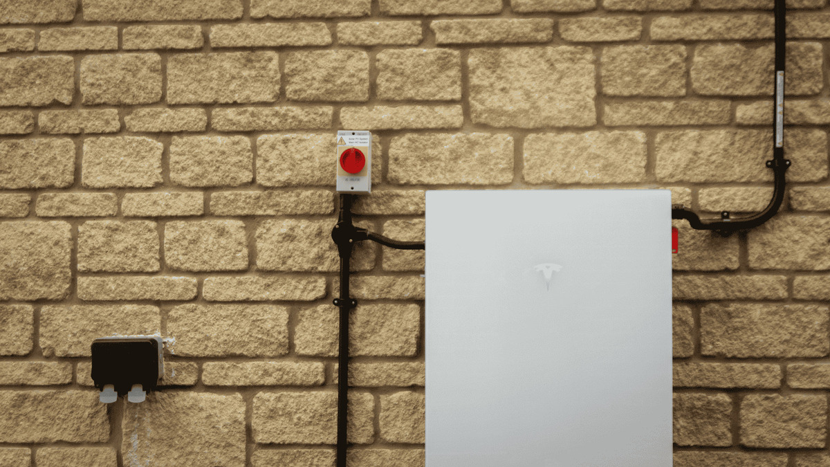 Tesla Powerwall installed against wall